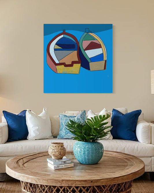 “Better Together” by Andrew French displayed above a coastal-inspired living room sofa, complementing ocean-toned decor with its vibrant blue palette and abstract boat design.