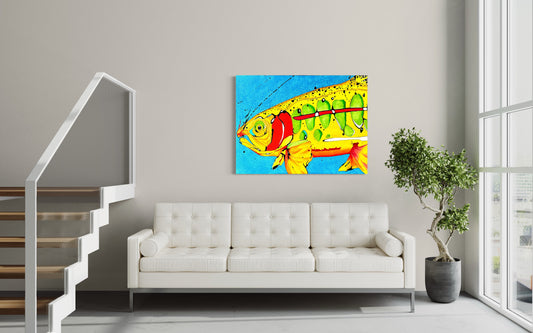 “Big Fish Little Lie” by Andrew French displayed above a modern white sofa in a bright living room with a staircase and indoor plant, showcasing the artwork’s bold yellow, green, and red tones against a vivid blue background.