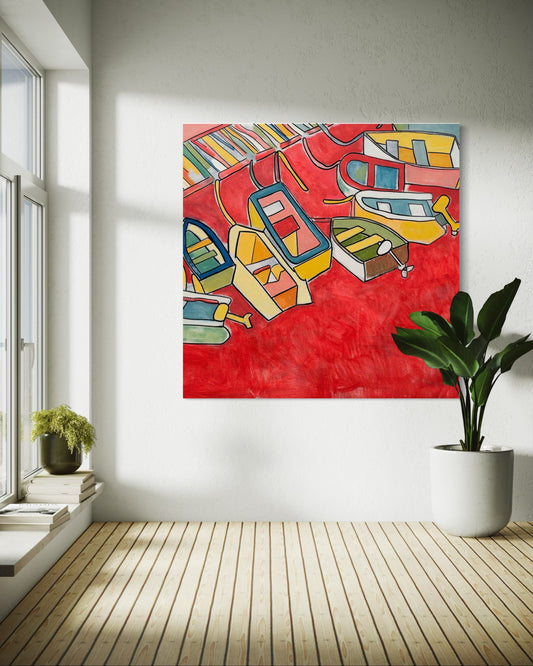 “Red Sea” by Andrew French displayed in a bright, minimalist room beside a green plant and large window, highlighting the painting’s bold red tones and abstract boat details.