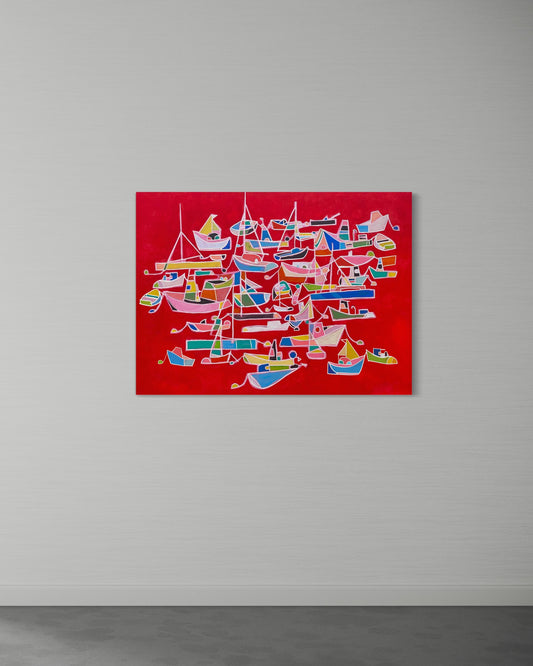 “Sea of Emotion” by Andrew French displayed on a minimalist wall, showcasing its bright red backdrop and colorful abstract boats for a striking modern statement.