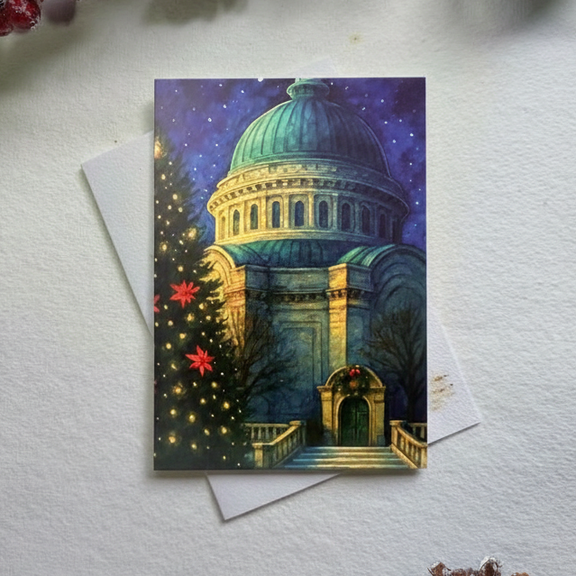 Decorative card with architectural design on a white surface with red berries and a pine cone.