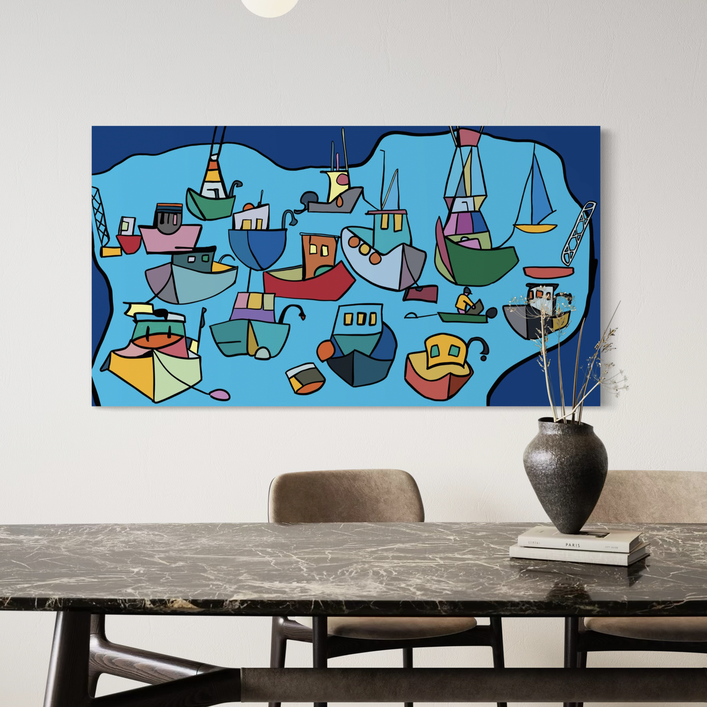 “Drifting Into Serenity” by Andrew French displayed above a marble dining table in a contemporary home, showcasing its vivid blue tones and colorful abstract boats that bring calm energy to the space.