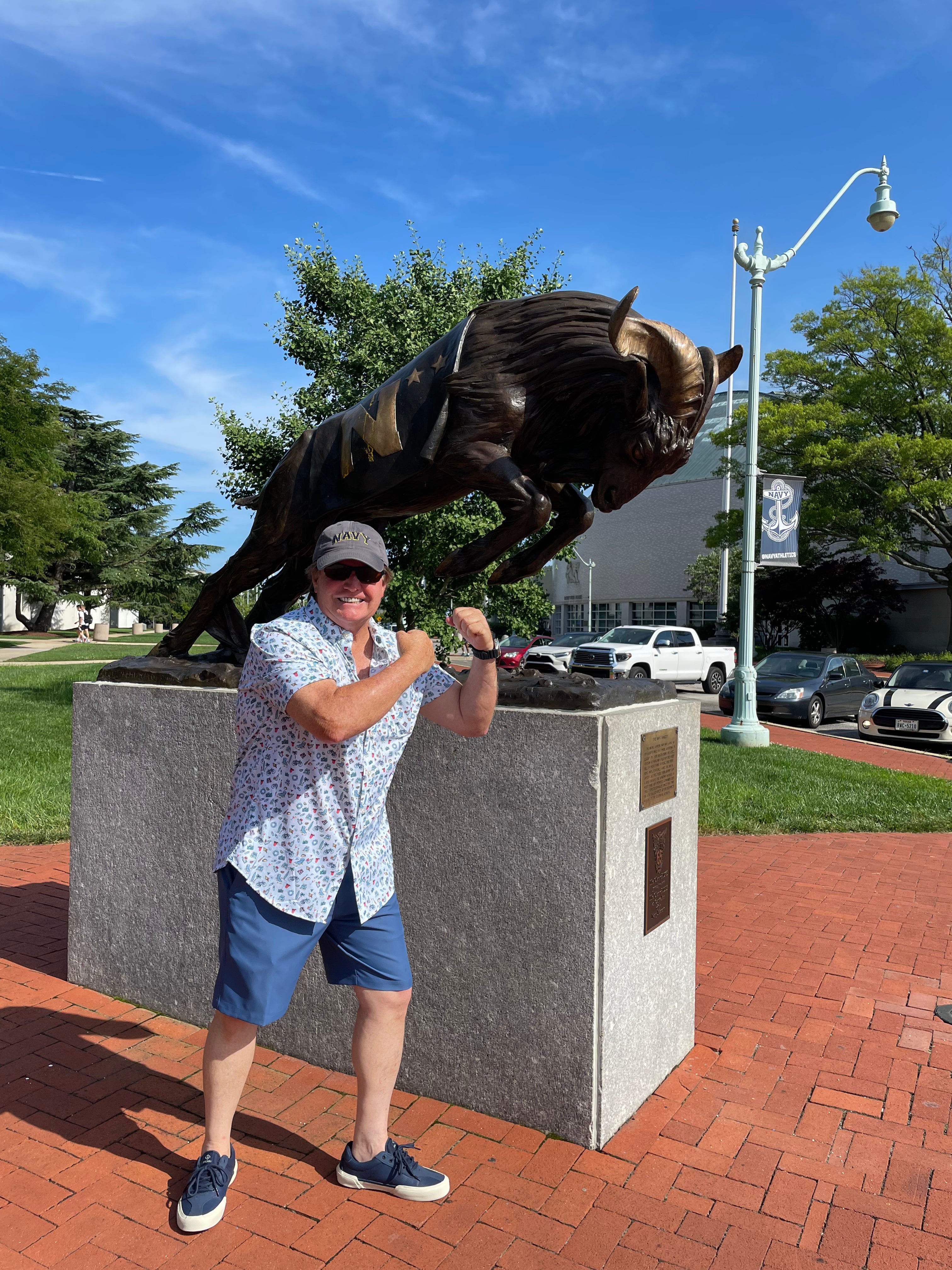 Co-founder Dan West, a U.S. Navy veteran, standing beside the Navy buffalo statue in Annapolis. The photo represents the pride, craftsmanship, and military roots behind the Market Street Merchants Military Collection.