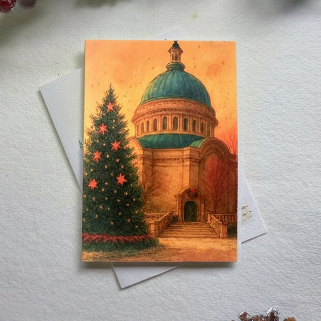 Christmas card with a church and tree design on a white surface with decorative elements.