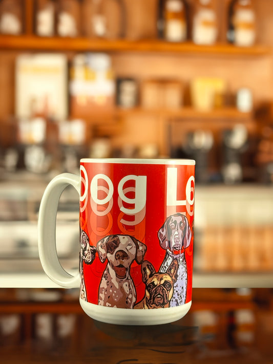 A vibrant red ceramic mug featuring Andrew French’s “Red Dogs” design. The artwork showcases a lineup of expressive dog portraits, including breeds like pointers and French bulldogs, rendered in a colorful, modern pop-art style. A perfect collectible for dog and art lovers alike.