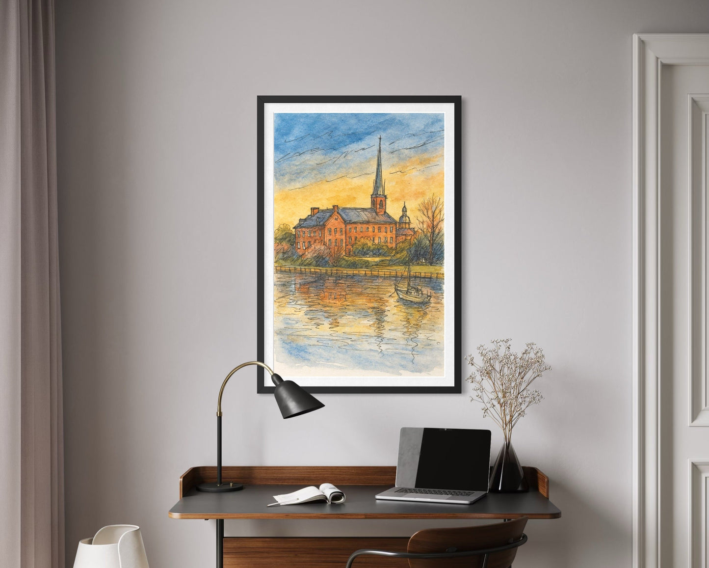 A framed artwork showcased above a modern writing desk with a laptop and reading lamp. Neutral tones and soft textures create a calm, stylish home office look.