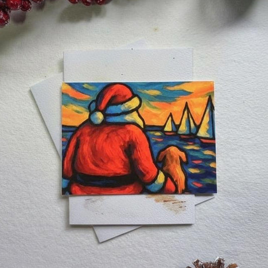 Colorful greeting card with Santa Claus and a dog on a white surface with decorative elements.