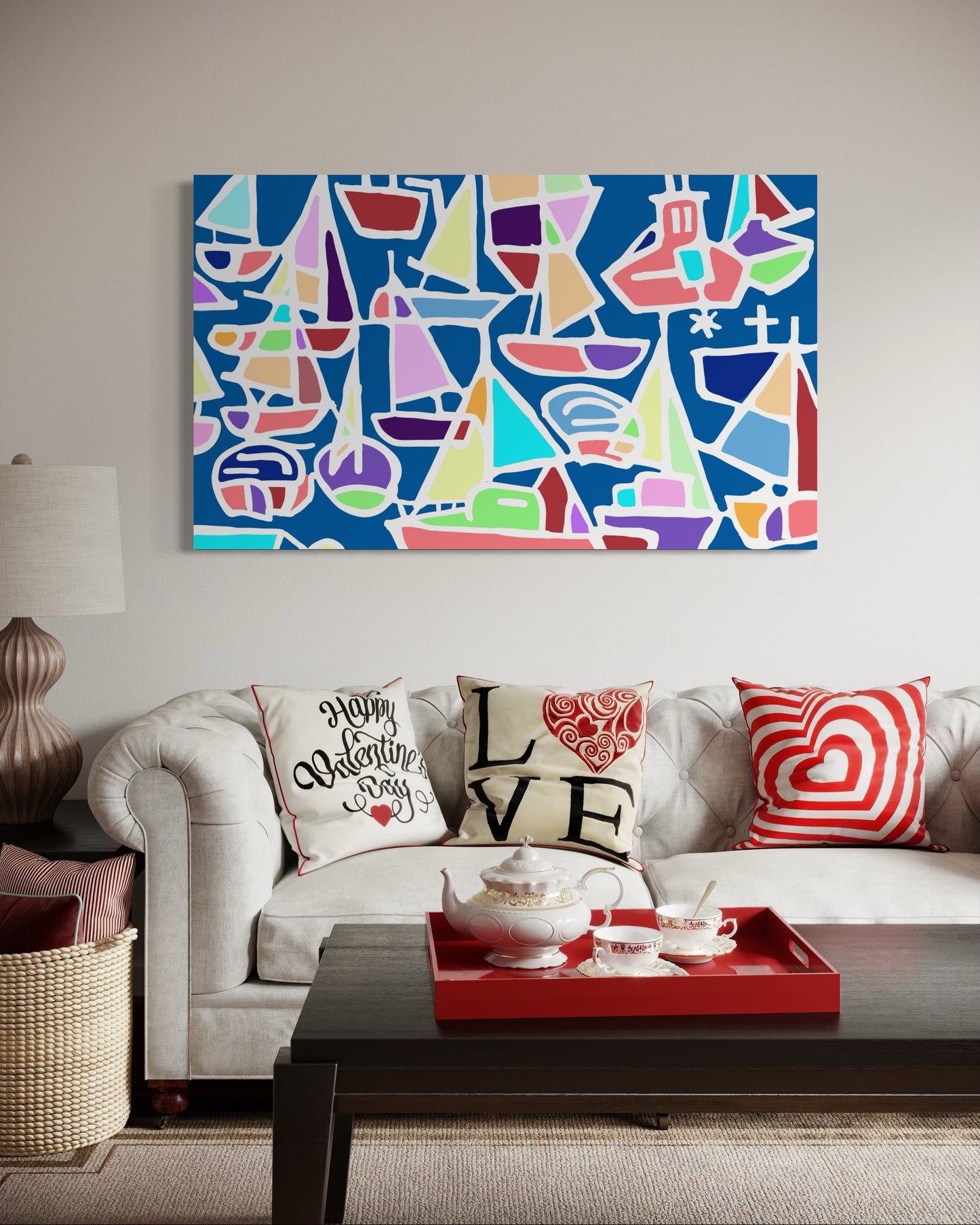 “Toy Boats” by Andrew French displayed above a white sofa with red and cream Valentine-themed pillows, adding a pop of color and coastal energy to the living room décor.
