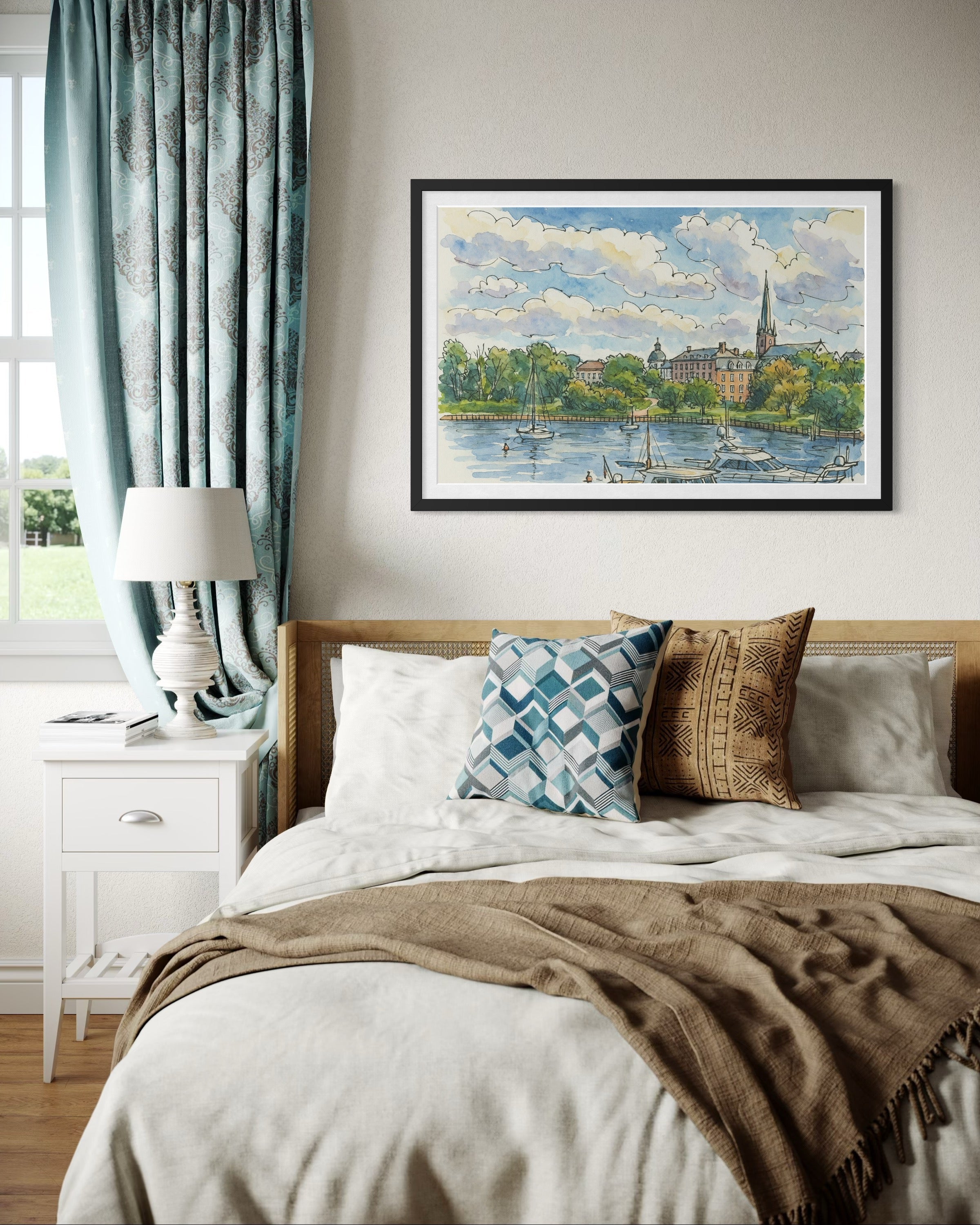 A framed artwork displayed above a bed in a cozy bedroom with soft blue curtains and textured pillows. Natural light highlights the artwork as the centerpiece of the space.
