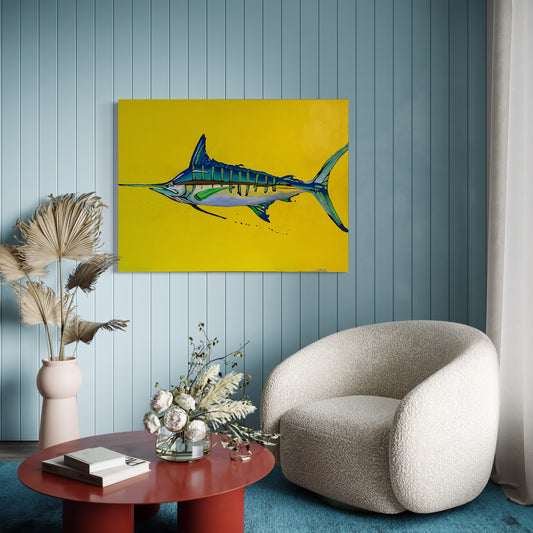 “Yellow Fin” by Andrew French displayed in a modern coastal room with soft blue walls and a cozy chair, showcasing the vibrant contrast between the marlin’s blue tones and the bold yellow background.